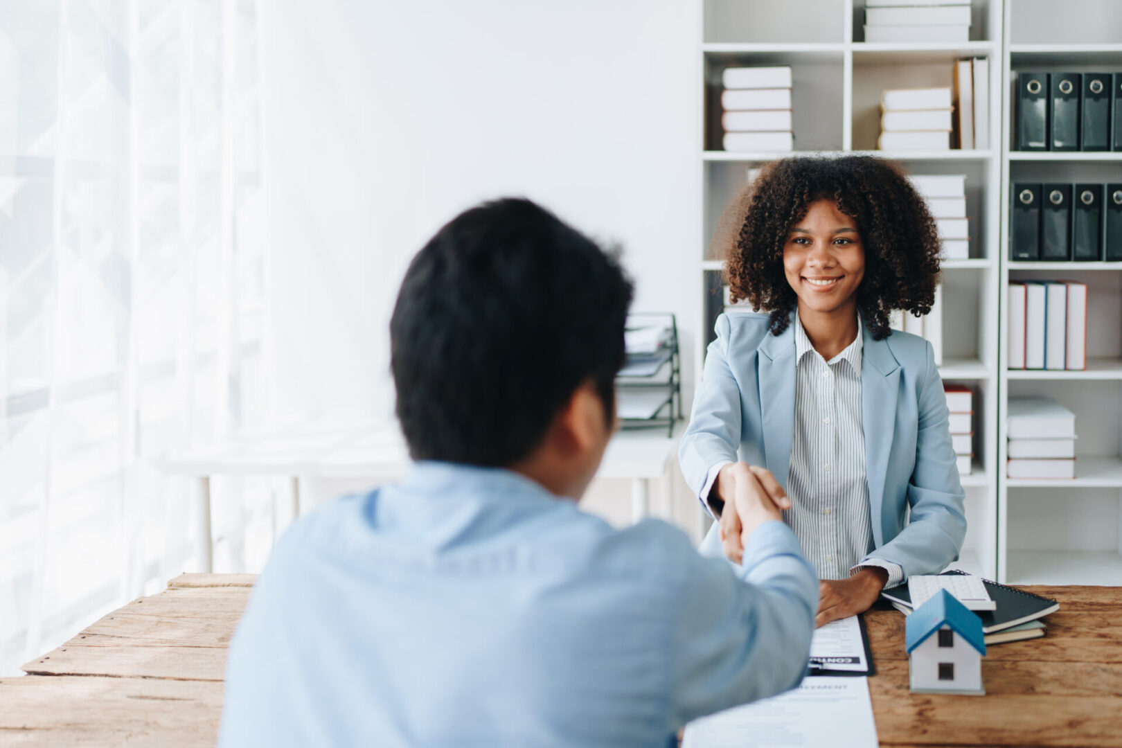 Two professionals engaged in a positive office conversation.